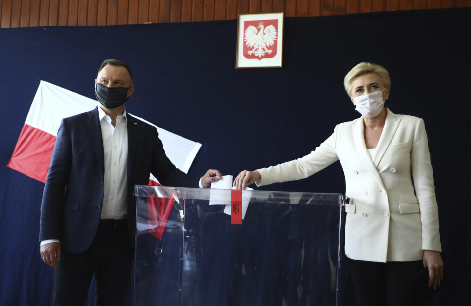 FILE - In this June 28, 2020, file photo, Poland's President Andrzej Duda and his wife Agata Kornhauser-Duda cast their vote during presidential election in Krakow, Poland. Duda and Warsaw Mayor Rafal Trzaskowski are heading into a tight presidential runoff that is seen as an important test for populism in Europe. The Sunday, July 12 election comes after a bitter campaign that has exacerbated a conservative-liberal divide in the country. (AP Photo/Beata Zawrzal, File)