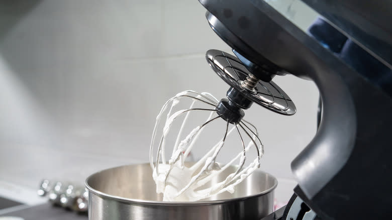Whipped cream in black stand mixer