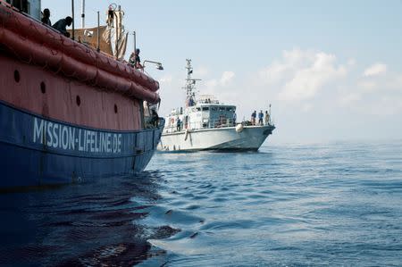 A Libyan coast guard vessel is seen next to the Mission Lifeline rescue boat in the central Mediterranean Sea, June 21, 2018. Hermine Poschmann/Misson-Lifeline/Handout via REUTERS