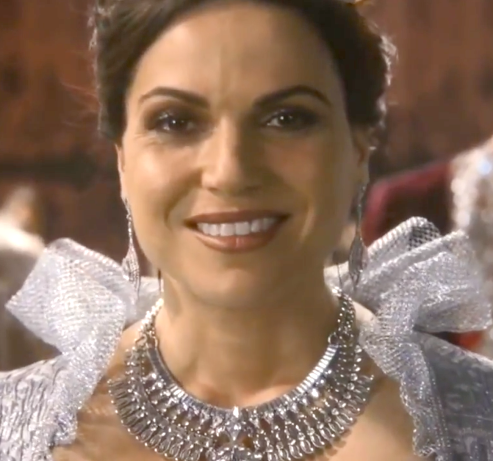 Regina smiling as she's crowned