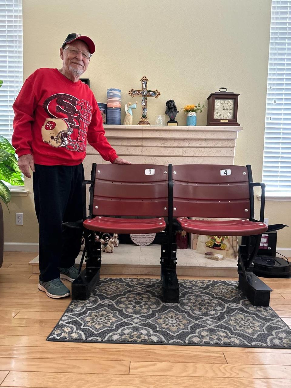 Nearly 90 Niners fan James Valdivia of Modesto stands by the two seats from Candlestick Park he got as souvenirs after the stadium was torn down.