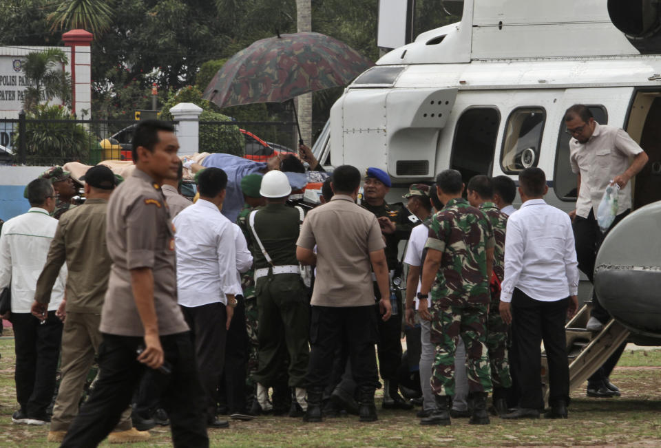 Soldiers carry Indonesian Coordinating Minister for Politics, Law and Security Wiranto on a stretcher to a waiting helicopter to be evacuated to Jakarta, in Pandeglang, Banten province, Indonesia, Thursday, Oct. 10, 2019. Indonesian police officials say Wiranto and two other people, including a local police chief, have been wounded by a knife-wielding man and taken to a hospital during a visit to a western province. (AP Photo/Rafsanjani)