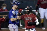 Arizona Diamondbacks' Wyatt Mathisen celebrates his two run home run as Texas Rangers catcher Sam Huff looks away during the sixth inning of a baseball game, Wednesday, Sept. 23, 2020, in Phoenix. (AP Photo/Matt York)