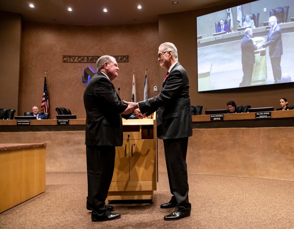 Rancho Mirage Mayor Steve Downs, right, shakes hands with newly appointed Councilmember Michael O’Keefe on Thursday in city hall's council chamber.