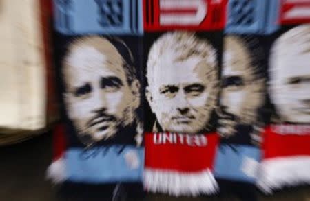 Football Soccer Britain - Manchester United v Manchester City - EFL Cup Fourth Round - Old Trafford - 26/10/16 Scarves with the faces of Manchester City manager Pep Guardiola and Manchester United manager Jose Mourinho are sold outside the stadium before the match Action Images via Reuters / Jason Cairnduff Livepic EDITORIAL USE ONLY. No use with unauthorized audio, video, data, fixture lists, club/league logos or "live" services. Online in-match use limited to 45 images, no video emulation. No use in betting, games or single club/league/player publications. Please contact your account representative for further details.