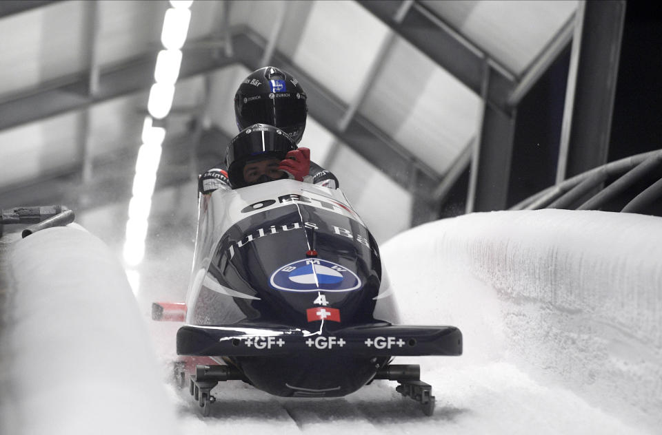 Michael Vogt and Sandro Michel of Switzerland finish their second run of the two man Bobsled World Cup race in Sigulda, Latvia, Sunday, Nov. 22, 2020. (AP Photo/Roman Koksarov)