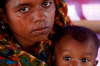 Aisha Begum, a-19 year-old Rohingya refugee, holds her daughter and cries as she tells her story at the camp for widows and orphans inside the Balukhali camp near Cox's Bazar, Bangladesh, December 5, 2017. Aisha Begum said her husband was killed by Myanmar soldiers as their band of refugees headed for Bangladesh. "I was sitting there by his body and just crying, crying, crying," she said. "He was caught and killed with knives. I found his body by the road. It was in three pieces," she cried, recounting the events that brought her to the camp. Aisha Begum now lives with her two children and more than 230 others at the camp for Rohingya widows and orphans. REUTERS/Damir Sagolj