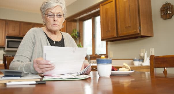 Mature Woman Looking at Household Bills