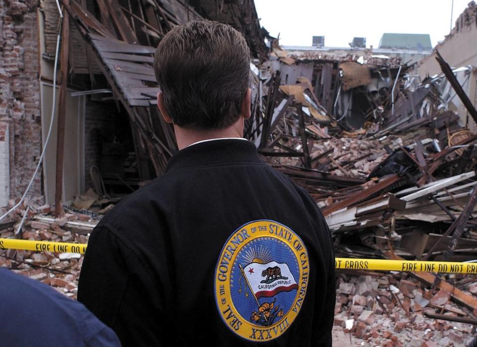 California Gov. Arnold Schwarzenegger views damage in downtown Paso Robles before declaring San Luis Obispo County a disaster area in the wake of the San Simeon Earthquake . This was the site of the House of Bread.