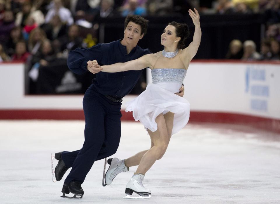 Tessa Virtue and Scott Moir perform their free program in dance competition at the Canadian figure skating championships in Ottawa, Ontario, on Saturday, Jan. 11, 2014. (AP Photo/The Canadian Press, Adrian Wyld)