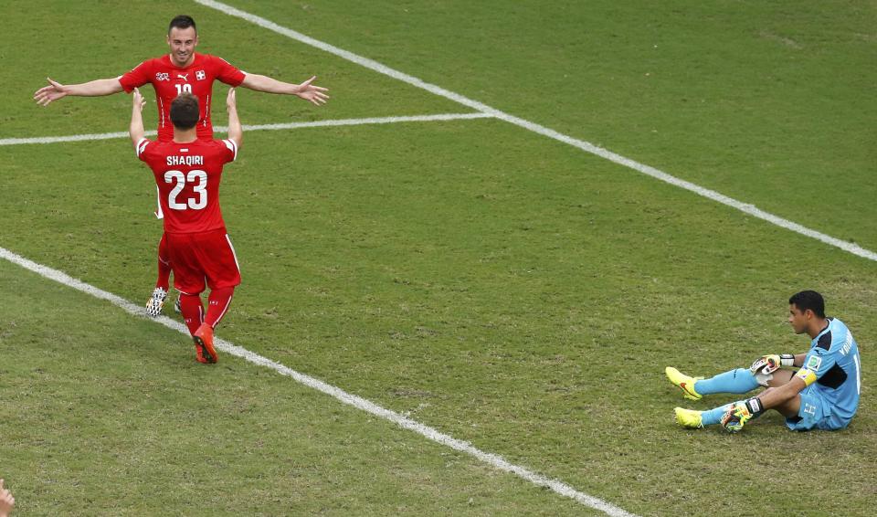 Switzerland's Xherdan Shaqiri (23) celebrates with a teammate after scoring against Honduras for his hat-trick during their 2014 World Cup Group E soccer match at the Amazonia arena in Manaus June 25, 2014. REUTERS/Andres Stapff (BRAZIL - Tags: SOCCER SPORT WORLD CUP)