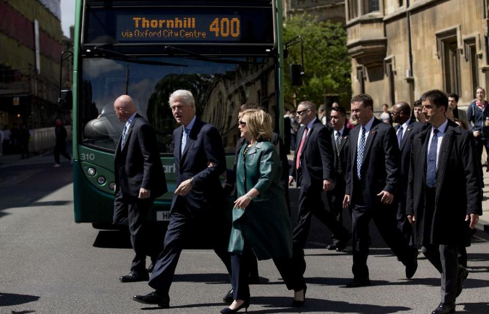 Former U.S. President Bill Clinton, second left, and his wife former Secretary of State Hillary Rodham Clinton, third left, cross the street with secret service officers after they attended their daughter Chelsea's Oxford University graduation ceremony held at the Sheldonian Theatre in Oxford, England, Saturday, May 10, 2014. Chelsea Clinton received her doctorate degree in international relations on Saturday from the prestigious British university. Her father was a Rhodes scholar at Oxford from 1968 to 1970. The graduation ceremony comes as her mother is considering a potential 2016 presidential campaign. (AP Photo/Matt Dunham)