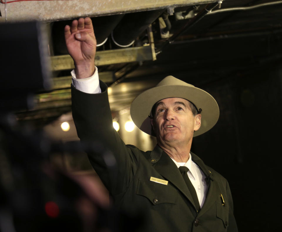 David Luchsinger, the superintendent for Ellis Island and the neighboring Statue of Liberty, shows journalists how high the water rose in the basement of a building on Ellis Island in New York, Monday, Oct. 28, 2013. The island that ushered millions of immigrants into the United States received visitors Monday for the first time since Superstorm Sandy. Sandy swamped boilers and electrical systems and left the 27.5-acre island without power for months. (AP Photo/Seth Wenig)