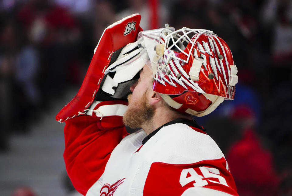 Detroit Red Wings goaltender Magnus Hellberg (45) wipes his face during a break in play while taking on the Ottawa Senators during second-period NHL hockey game action in Ottawa, Ontario, Monday, Feb. 27, 2023. (Sean Kilpatrick/The Canadian Press via AP)