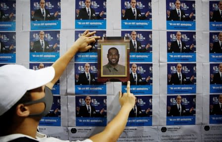 A protester puts a NBA star Lebron James' photo on a wall during a gathering in support of NBA's Houston Rockets' team general manager Daryl Morey, who sent a tweet backing the pro-democracy movement, in Hong Kong