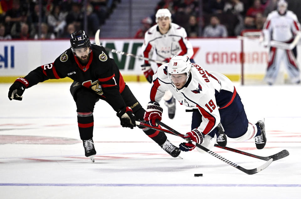 Ottawa Senators center Mark Kastelic (12) trips up Washington Capitals center Nicklas Backstrom (19) during the second period of an NHL hockey game in Ottawa, Ontario on Wednesday, Oct. 18, 2023. (Justin Tang/The Canadian Press via AP)