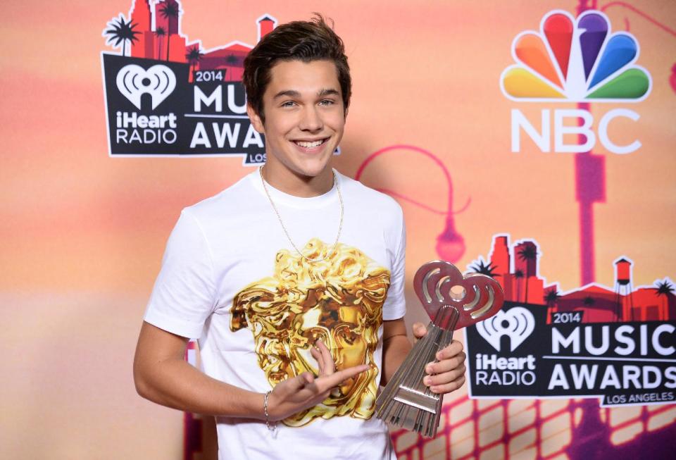 Austin Mahone poses in the press room with the award for iHeartRadio Instagram at the iHeartRadio Music Awards at the Shrine Auditorium on Thursday, May 1, 2014, in Los Angeles. (Photo by Jordan Strauss/Invision/AP)