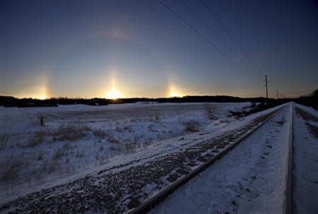 A "sun dog" atmospheric phenomenon appears as the sun rises in southern Minnesota, January 27, 2014. REUTERS/Eric Miller