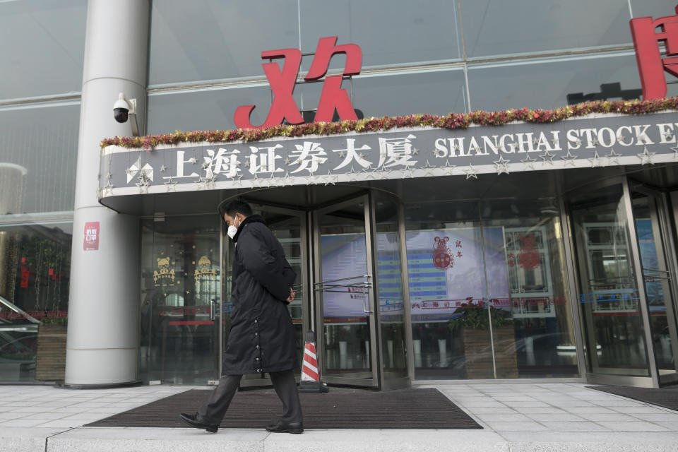 A security officer wearing a face mask walks in front of the Shanghai Stock Exchange building in Shanghai, Monday, Feb. 3, 2020. The Shanghai Composite index tumbled 8.7% Monday then rebounded slightly as Chinese regulators moved to stabilize markets reopening from a prolonged national holiday despite a rising death toll from a new virus that has spread to more than 20 countries. (AP Photo)