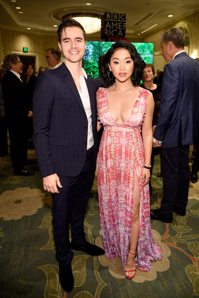 Anthony wearing a suit as he poses for a photo with Lana, who's wearing a low-cut dress at an event