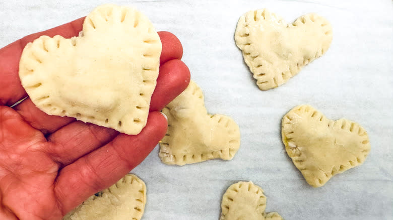 sealed pastry heart in hand