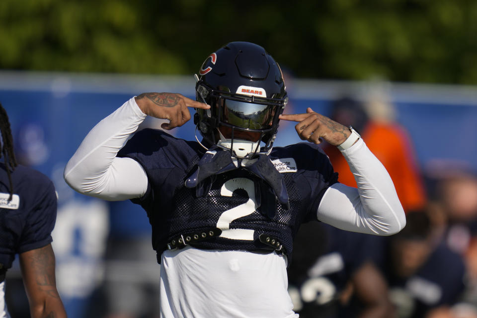 Chicago Bears wide receiver DJ Moore gestures as he warms up during a joint practice with the Indianapolis Colts at the NFL team's football training camp in Westfield, Ind., Wednesday, Aug. 16, 2023. (AP Photo/Michael Conroy)