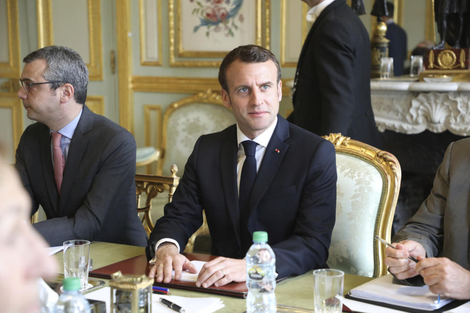 French President Emmanuel Macron flanked by Elysee general secretary Alexis Kohler, left, holds a meeting at the Elysee presidential Palace, in Paris, Monday, March 18, 2019. Macron summoned top security officials Monday after police failed to contain resurgent rioting during yellow vest protests that transformed a luxurious Paris avenue into a battle scene. (Ludovic Marin/Pool Photo via AP)
