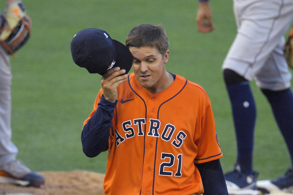 Houston Astros' Zack Greinke rubs his face as he is taken out of a baseball game during the seventh inning against the Los Angeles Angels, Saturday, Aug. 1, 2020, in Anaheim, Calif. (AP Photo/Mark J. Terrill)