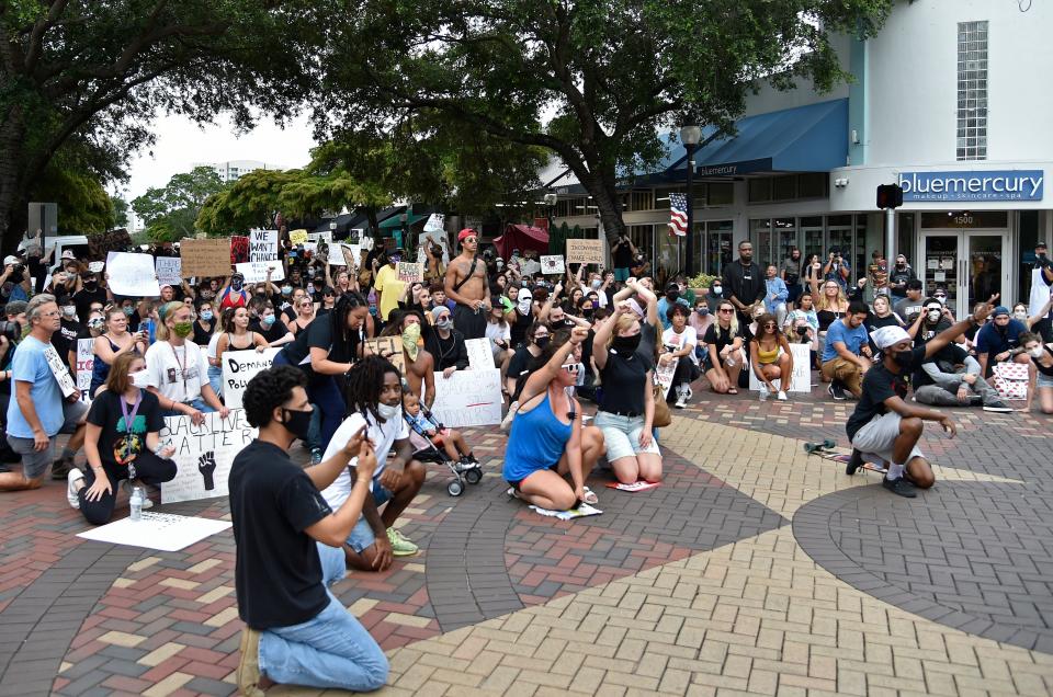 Demonstrators kneel in downtown Sarasota during a June 2020 march for racial justice.