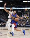 Denver Nuggets guard Jamal Murray (27) drives to the basket against the Los Angeles Lakers during the second half in Game 1 of an NBA basketball first-round playoff series Saturday, April 20, 2024, in Denver. (AP Photo/Jack Dempsey)