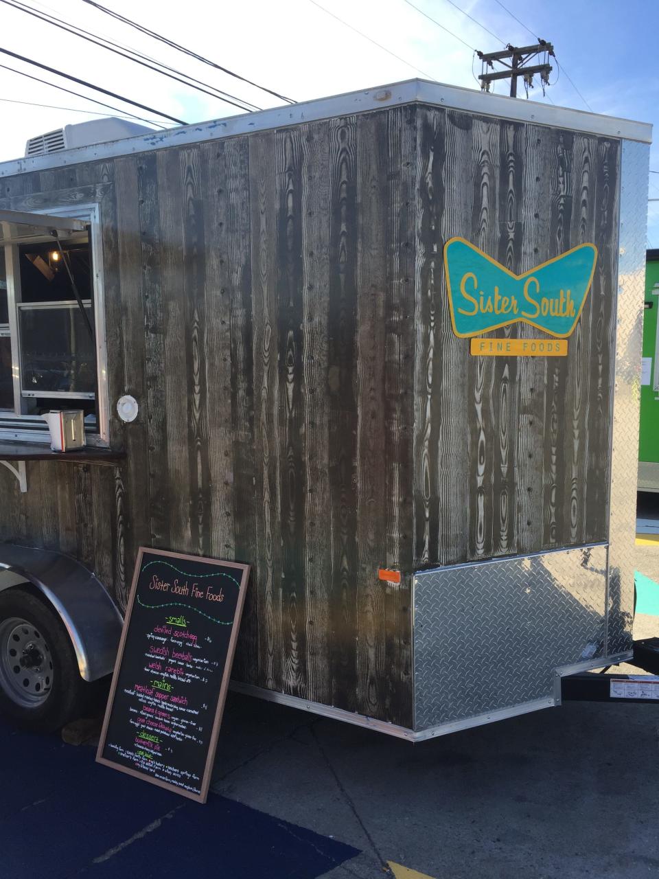 Bud Ries’ friend Jessica Hammonds, owner of Sister South Fine Foods, gave him full rein not only to design her logo, but also to paint the outside of her food trailer. “I had to figure out how to do the faux wood grain, it was a challenge with all of the rivets,” he said of the rustic effect. “People still walk up to it and put their hand out to touch it.”