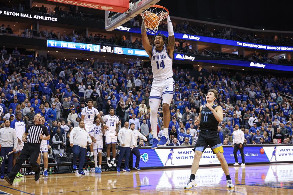 Seton Hall Pirates guard Dre Davis (14) dunks the ball during the second half in front of Tyler Kolek (11)