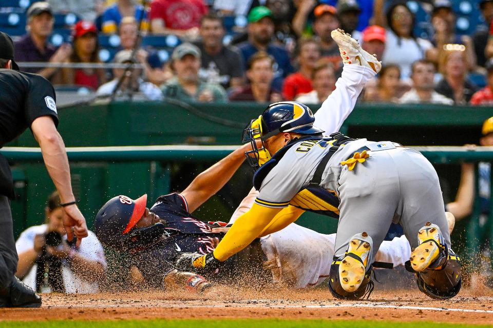 Brewers catcher William Contreras tags out Nationals first baseman Dominic Smith at home in a game last month.