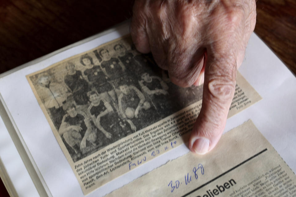 Makkabi Berlin co-founder Marian Wajselfisz points to the date below an old photo of the team during an interview with The Associated Press, in Berlin, Wednesday, July 26, 2023. When Makkabi Berlin takes the field on Sunday Aug. 13, 2023, the soccer club founded by Holocaust survivors will become the first Jewish team to play in the German Cup. (AP Photo/Ciaran Fahey)