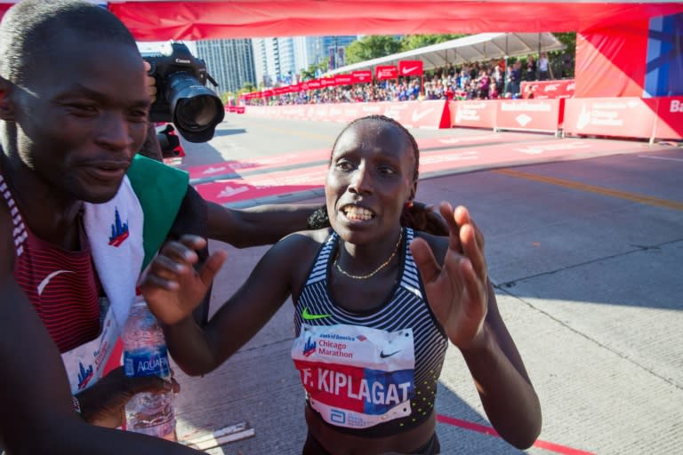 Abel Kirui congratulates Florence Kiplagat on the victory in the Chicago marathon women's race