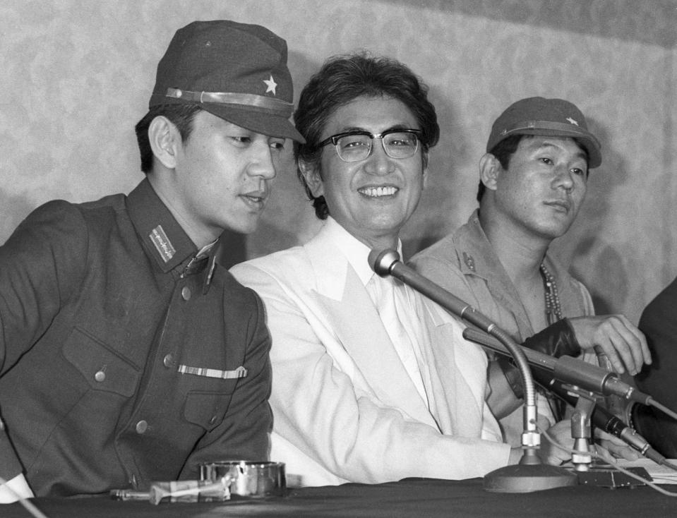 FILE - Japanese Director Nagisa Oshima, center, along with actors Ryuichi Sakamoto, left, and Takeshi Kitano, right, attends a press conference for his film " Merry Christmas, Mr. Lawrence " in Tokyo July, 1982. Japan's recording company Avex says Sakamoto, a musician who scored for Hollywood movies such as “The Last Emperor” and “The Revenant,” has died. He was 71. He died March 28, according to the statement released Sunday, April 2, 2023.(Kyodo News via AP, File)