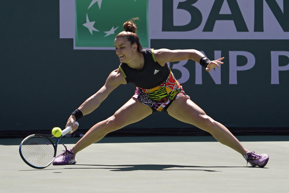 Maria Sakkari, of Greece,returns a shot to Iga Swiatek, of Poland, during the women's singles finals at the BNP Paribas Open tennis tournament Sunday, March 20, 2022, in Indian Wells, Calif. (AP Photo/Mark J. Terrill)