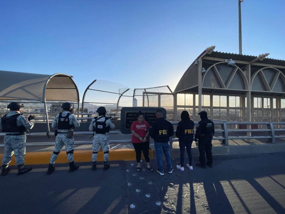 Mexican National Guard troops hand over Liliana Judith Salaices to FBI agents at the U.S.-Mexico border at the middle of the Stanton international bridge between El Paso, Texas, and Juarez, Mexico, on May 14.