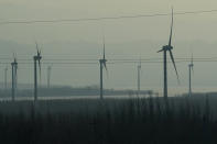 Windmills are seen from a high speed train traveling from Beijing to neighboring Zhangjiakou in northwestern China's Hebei province on Dec. 15, 2020. Expectations are high that the 14th five-year plan will align domestic policies with international pledges on climate change. Chinese President Xi Jinping made a surprise pledge at a United Nations meeting in September that China would go carbon neutral by 2060. (AP Photo/Ng Han Guan)