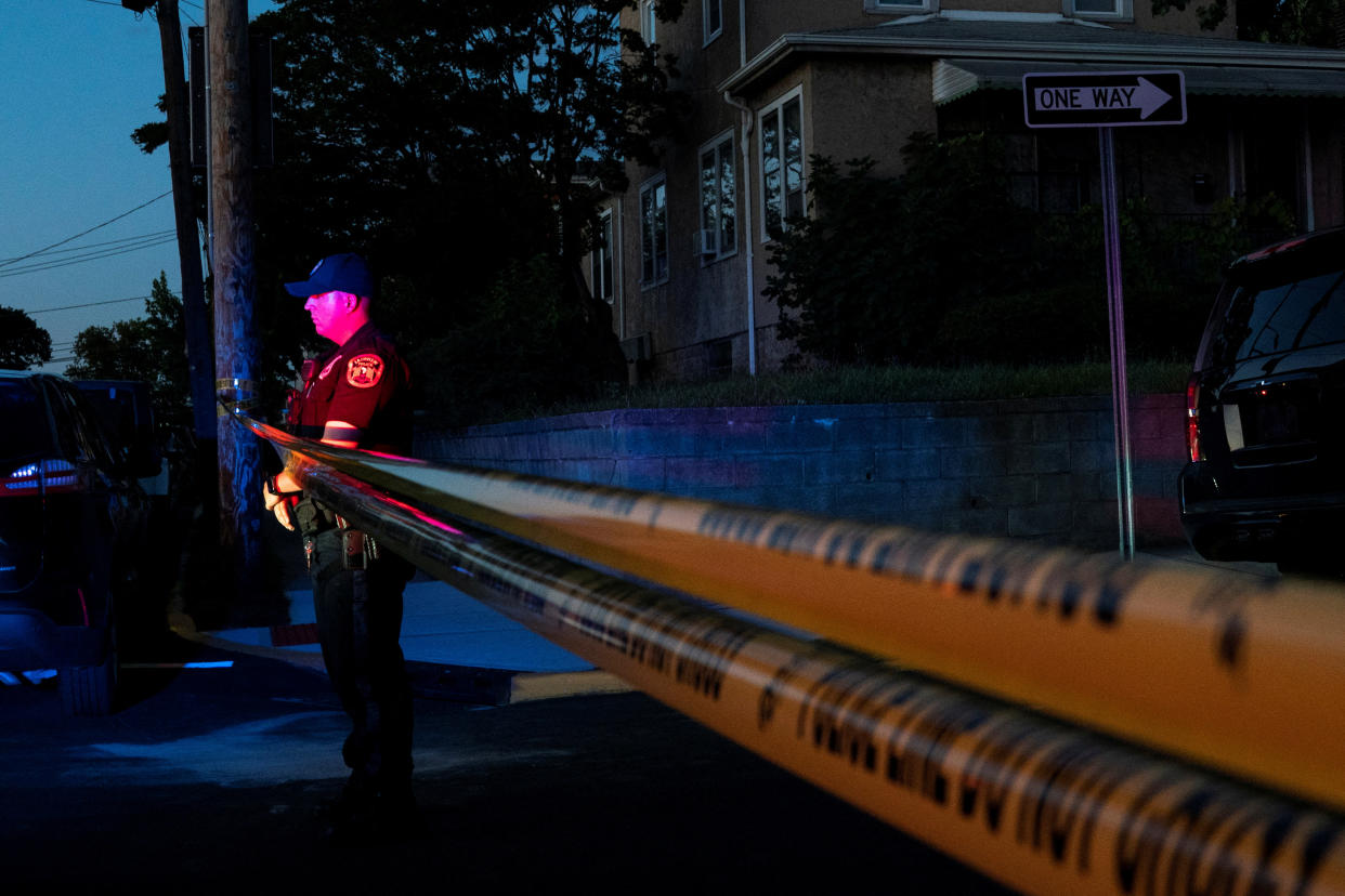 A New Jersey police officer stands guard near the building where Hadi Matar, the alleged attacker of Salman Rushdie, lives in Fairview, N.J. 