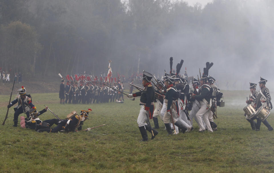 Members of historic clubs wearing 1812-era uniforms perform during a staged battle re-enactment to mark the 200th anniversary of the battle of Borodino, in Borodino, about 110 km (70 miles) west of Moscow, Sunday, Sept. 2, 2012. Russia marks on Sunday the 200th anniversary of the Battle of Borodino which in 1812 was the largest and bloodiest single-day action of the French invasion of Russia. (AP Photo/Alexander Zemlianichenko)