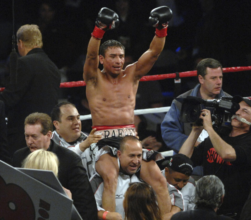 FILE - Rafael Marquez celebrates after winning the WBC super bantamweight crown over Israel Vazquez on Saturday, March 3, 2007, in Carson, Calif. Marquez, Timothy Bradley Jr. and Carl Froch were inducted Wednesday, Dec. 7, 2022, to the International Boxing Hall of Fame. (Stephen Carr/The Orange County Register via AP)