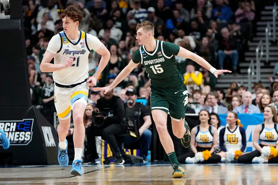 Mar 19, 2023; Columbus, Ohio, USA;  Michigan State Spartans center Carson Cooper (15) celebrates a shot beside Marquette Golden Eagles forward Ben Gold (21) during the second round of the NCAA men’s basketball tournament at Nationwide Arena. Mandatory Credit: Adam Cairns-The Columbus Dispatch