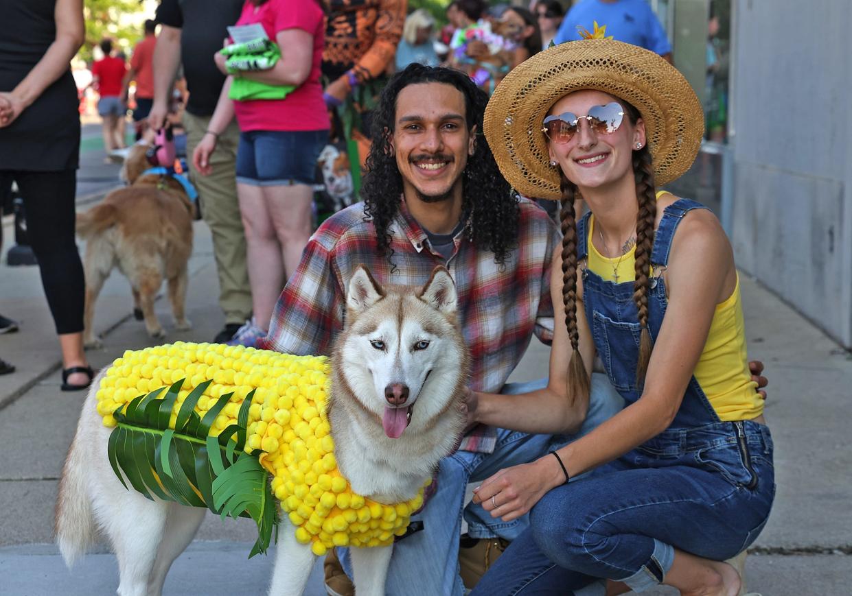 Mars, a husky, poses with its owners, Vinny Alvarez and Jess Brainerd. Friday, Aug. 4, 2023, at the pet parade in downtown Adrian during First Fridays.