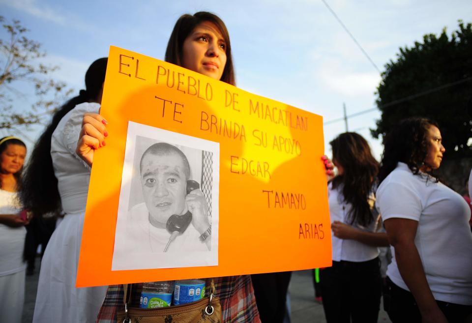 In this Jan. 19, 2014 photo, a woman holds up a sign showing a photo of Texas death-row inmate Edgar Tamayo that reads in Spanish "The town of Miacatlan offers you our support, Edgar Tamayo Arias" during a protest demanding Tamayo's pardon in his hometown of Miacatlan, Mexico. Lawyers for 46-year-old Edgar Tamayo are suing Gov. Rick Perry and the Texas Board of Pardons and Paroles, challenging what they argue is an unfair and secretive clemency process in Texas. Tamayo is set for lethal injection on Wednesday, Jan. 22 in Huntsville. (AP Photo/Tony Rivera)