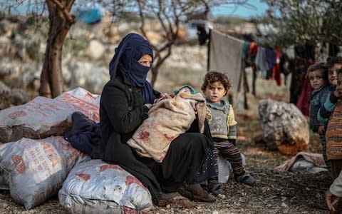 Families unable to find tents due to overcrowding sleep under the olive groves - Credit: Anadolu Agency&nbsp;