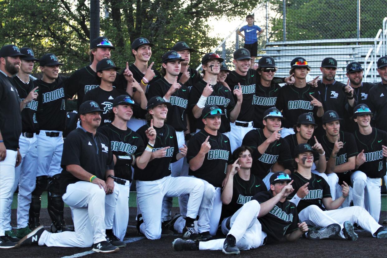 The Rock Bridge baseball team celebrates after winning the Central Missouri Athletic Conference baseball title after the Bruins' 4-3 win over Hickman in eight innings on May 3, 2023, at Hickman High School.