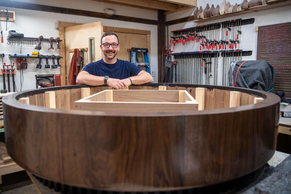 Craig Setzer and one of his coffee tables in progress at Foundation Woodworks in Asheville, March 4, 2024.