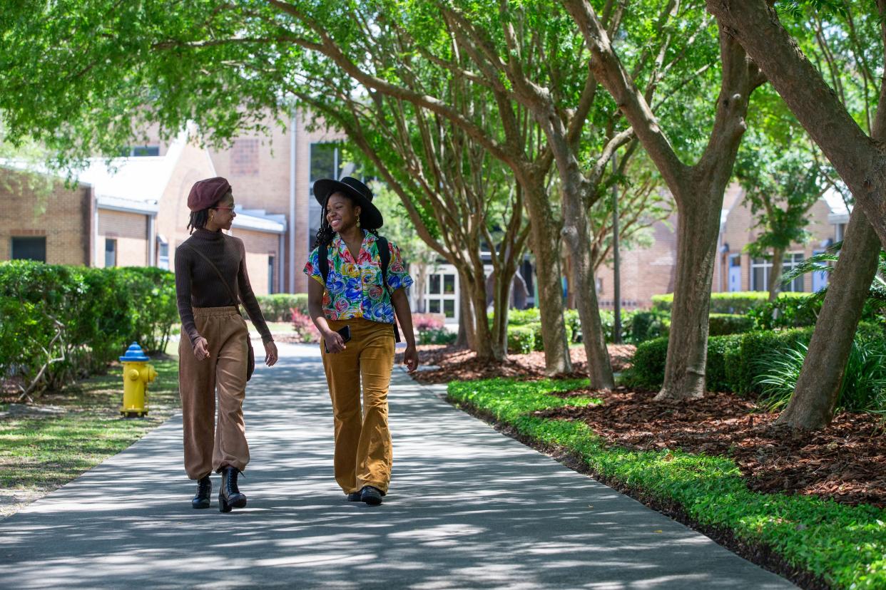 Llyana and her twin sister Saniah Maul talk with one another while they spend the afternoon on the Tallahassee Community College campus, where they are dual-enrolled, Wednesday, April 24, 2024. The pair are the Godby High School class of 2024 valedictorian and salutatorian.