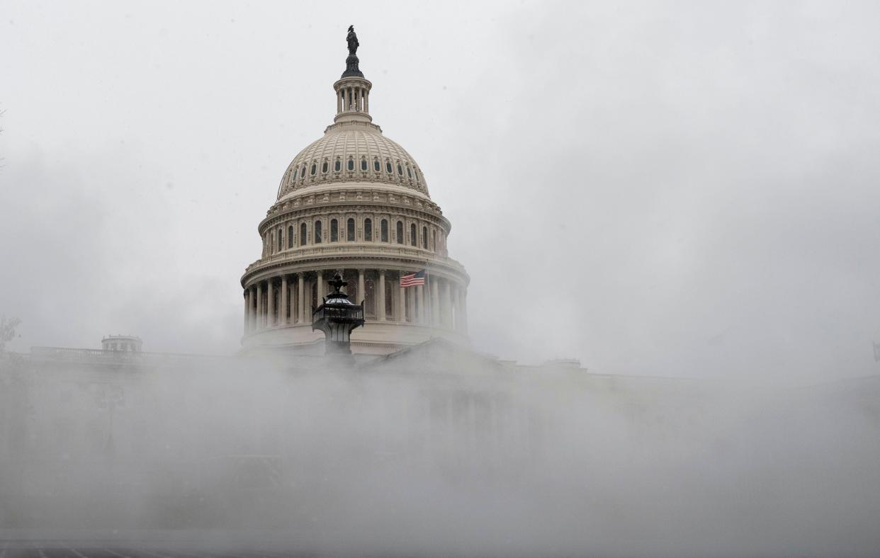 The US Capitol is enveloped with mist on Wednesday as much of the East Coast braces for snow (AFP via Getty Images)